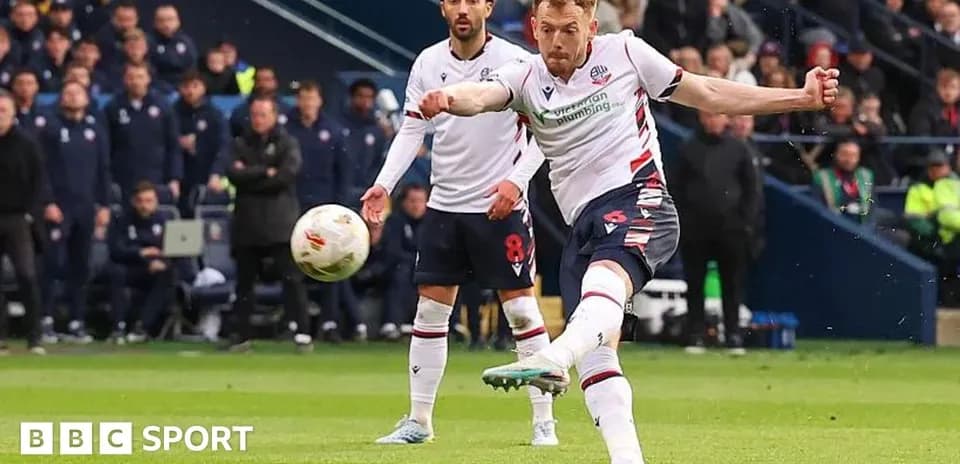 Player taking a penalty kick during match