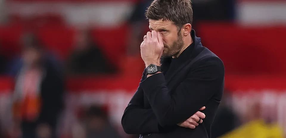 Coach with hand on face during match