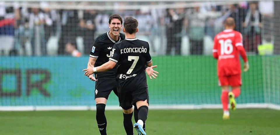 Two Juventus players celebrating a goal on field
