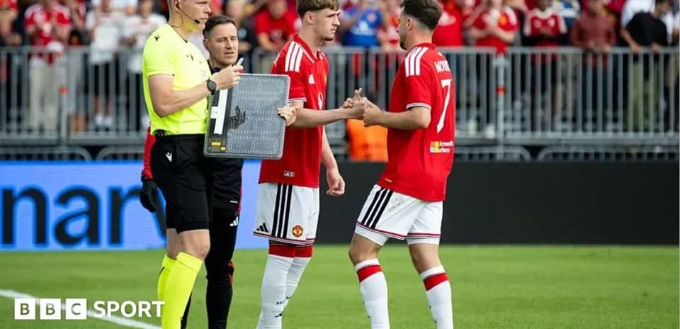 Players shaking hands during substitution in match