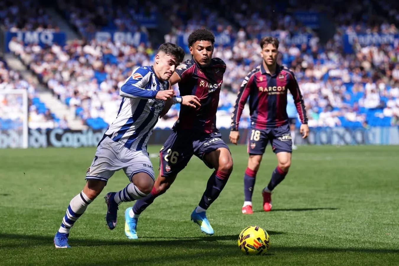 Real Sociedad player dribbling past Levante defender