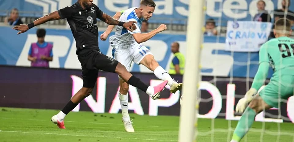 Universitatea Craiova player taking a shot on goal