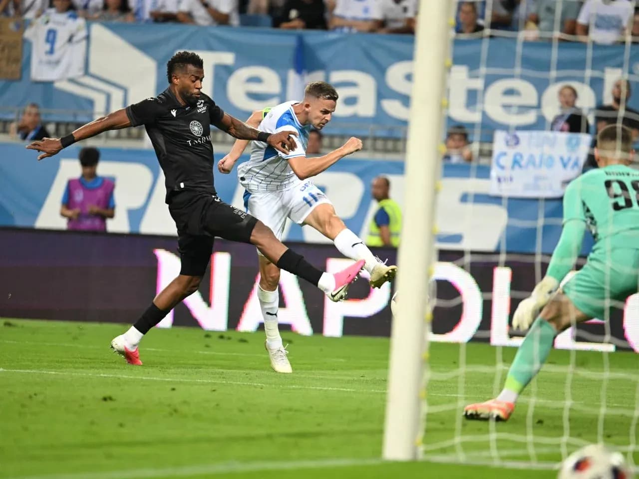Universitatea Craiova player taking a shot on goal