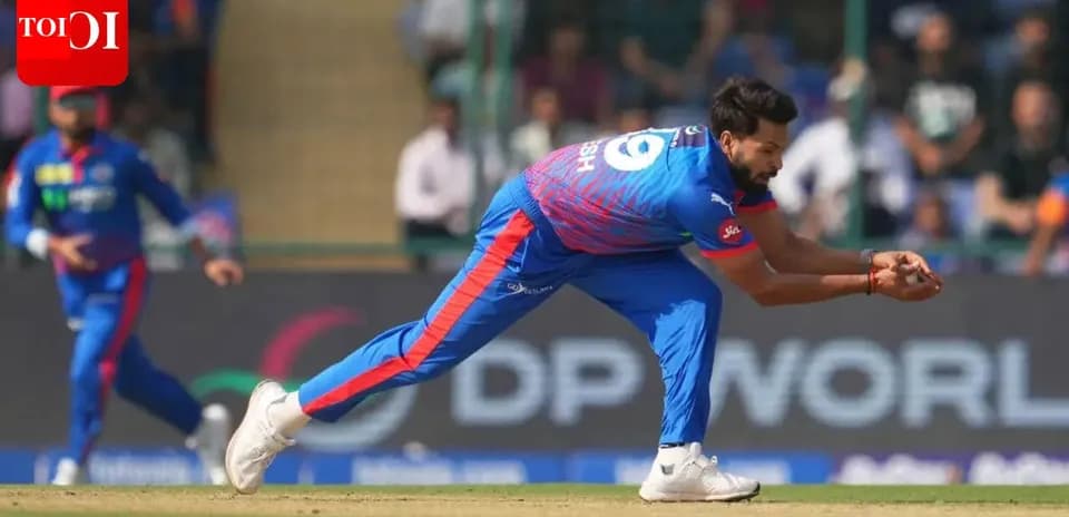 Fielder diving to catch a cricket ball