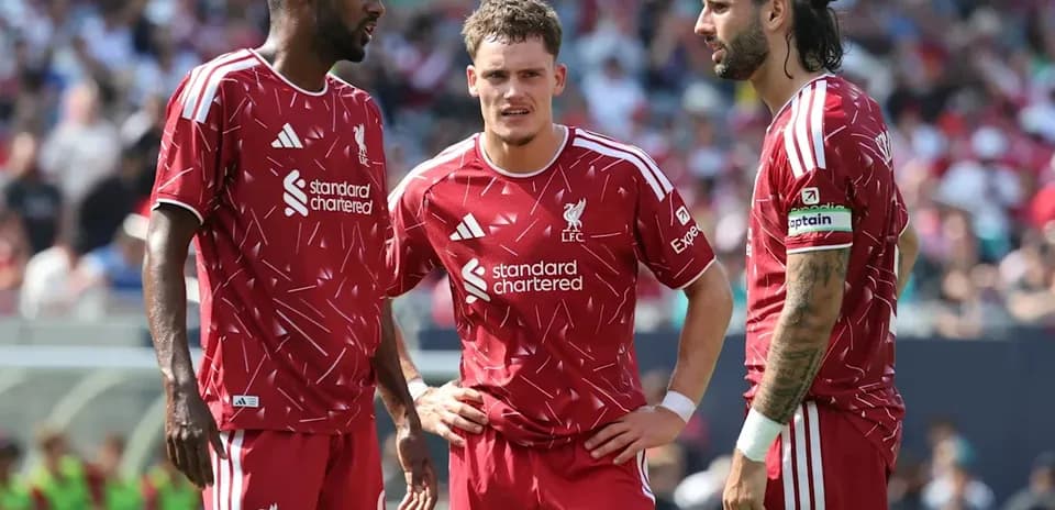 Liverpool players discussing strategy during a match
