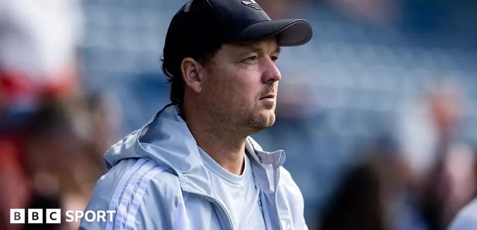Coach observing from the sidelines during match