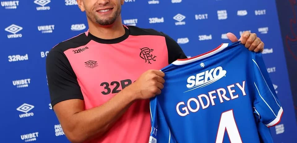 Player holding Rangers FC jersey with Godfrey printed