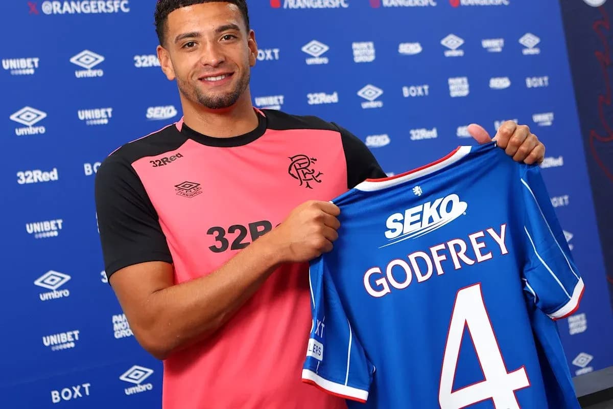 Player holding Rangers FC jersey with Godfrey printed