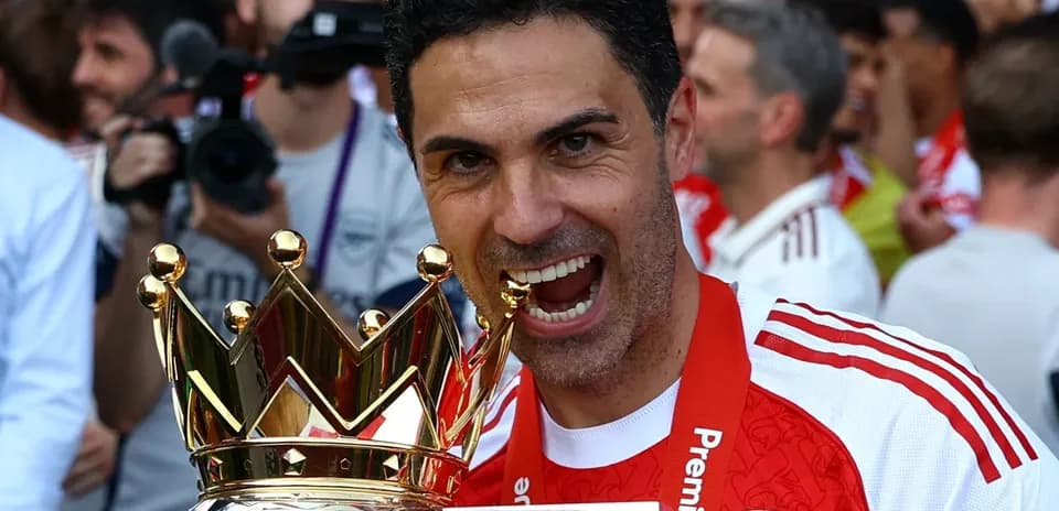 Coach celebrating with Premier League trophy