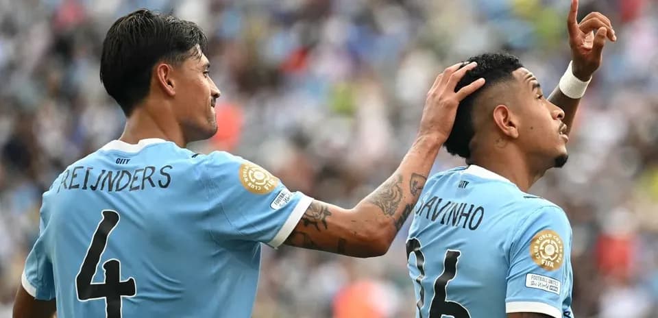 Two players celebrating on the field during match