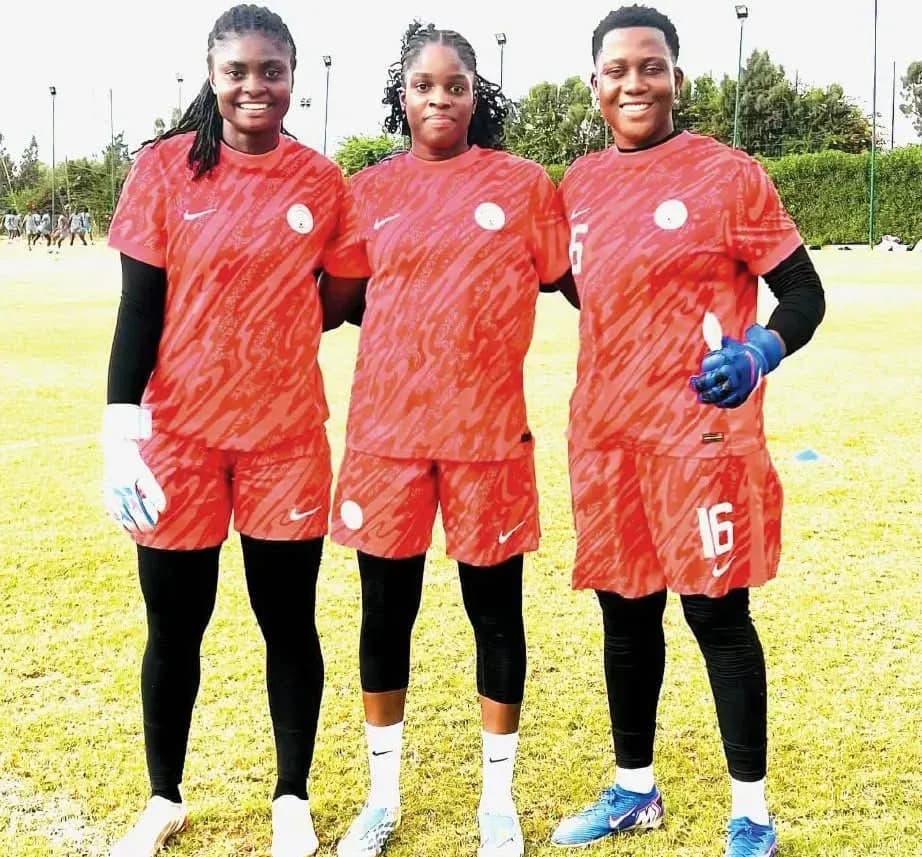Three female soccer players posing in training gear