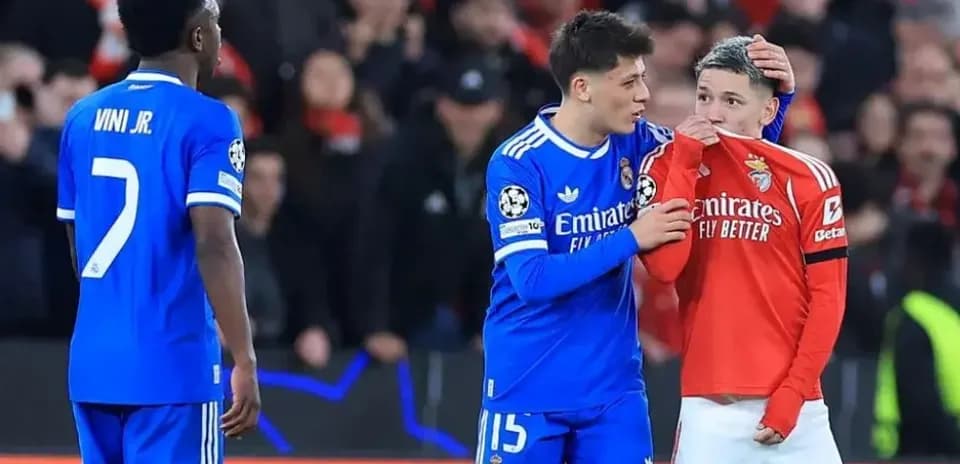 Real Madrid players comforting Benfica player on pitch
