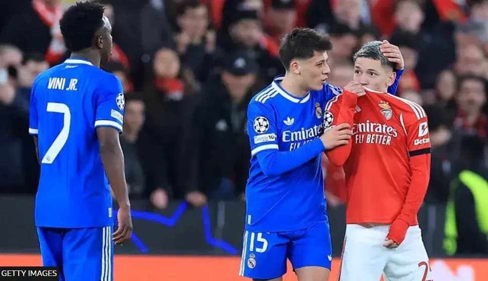 Real Madrid players comforting Benfica player on pitch