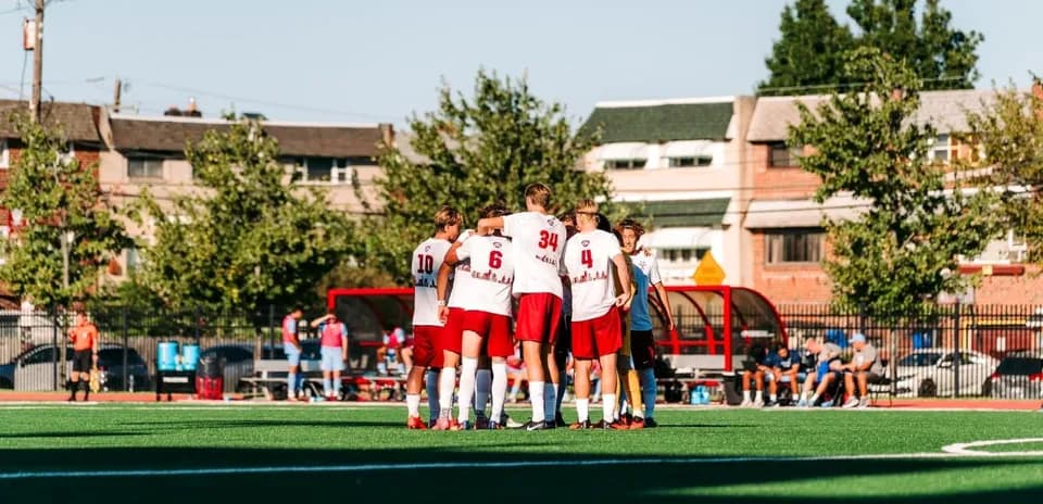 Team huddling before a match on the field