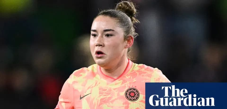 Goalkeeper in pink kit during match action
