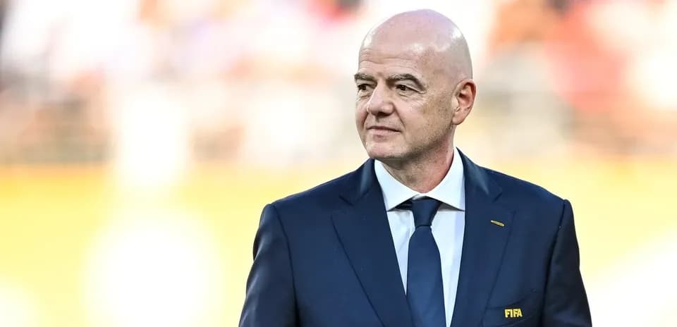 FIFA president walking on the pitch before match