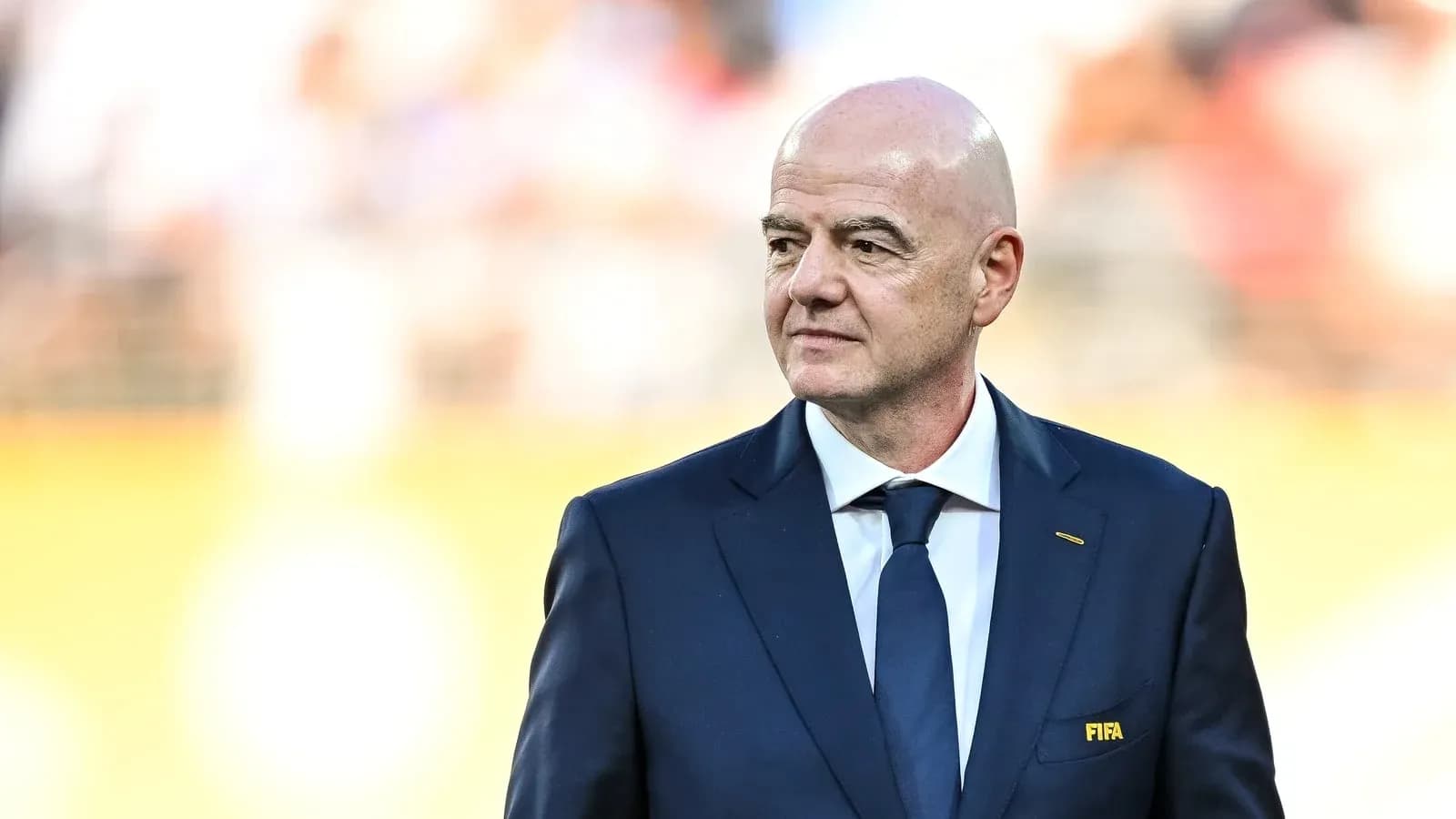 FIFA president walking on the pitch before match
