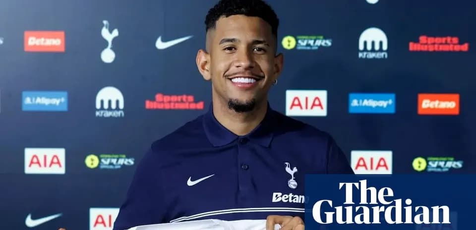 Player holding Tottenham Hotspur jersey at press event