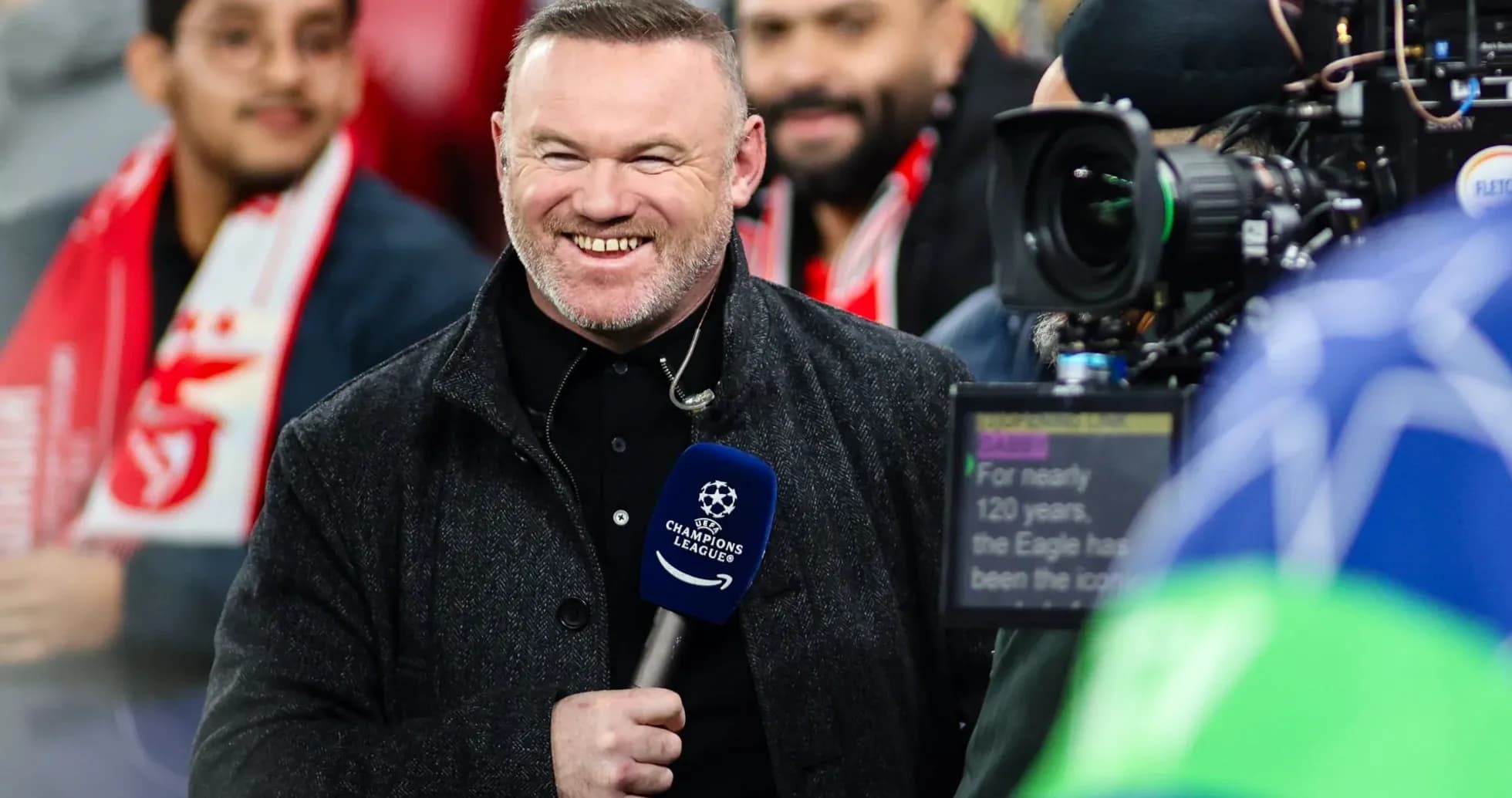 Presenter smiling with microphone before match