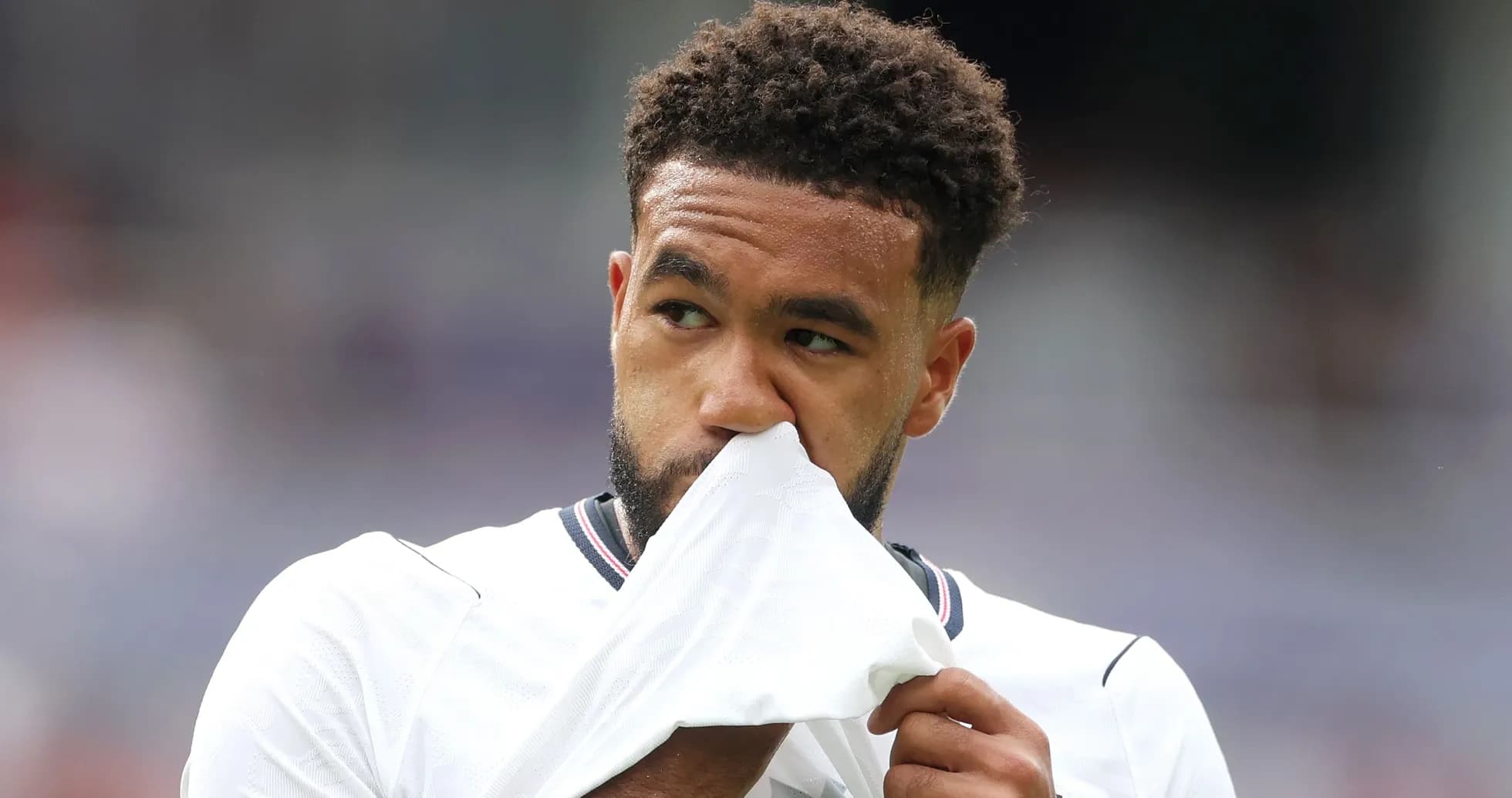 Player holding shirt to face during match