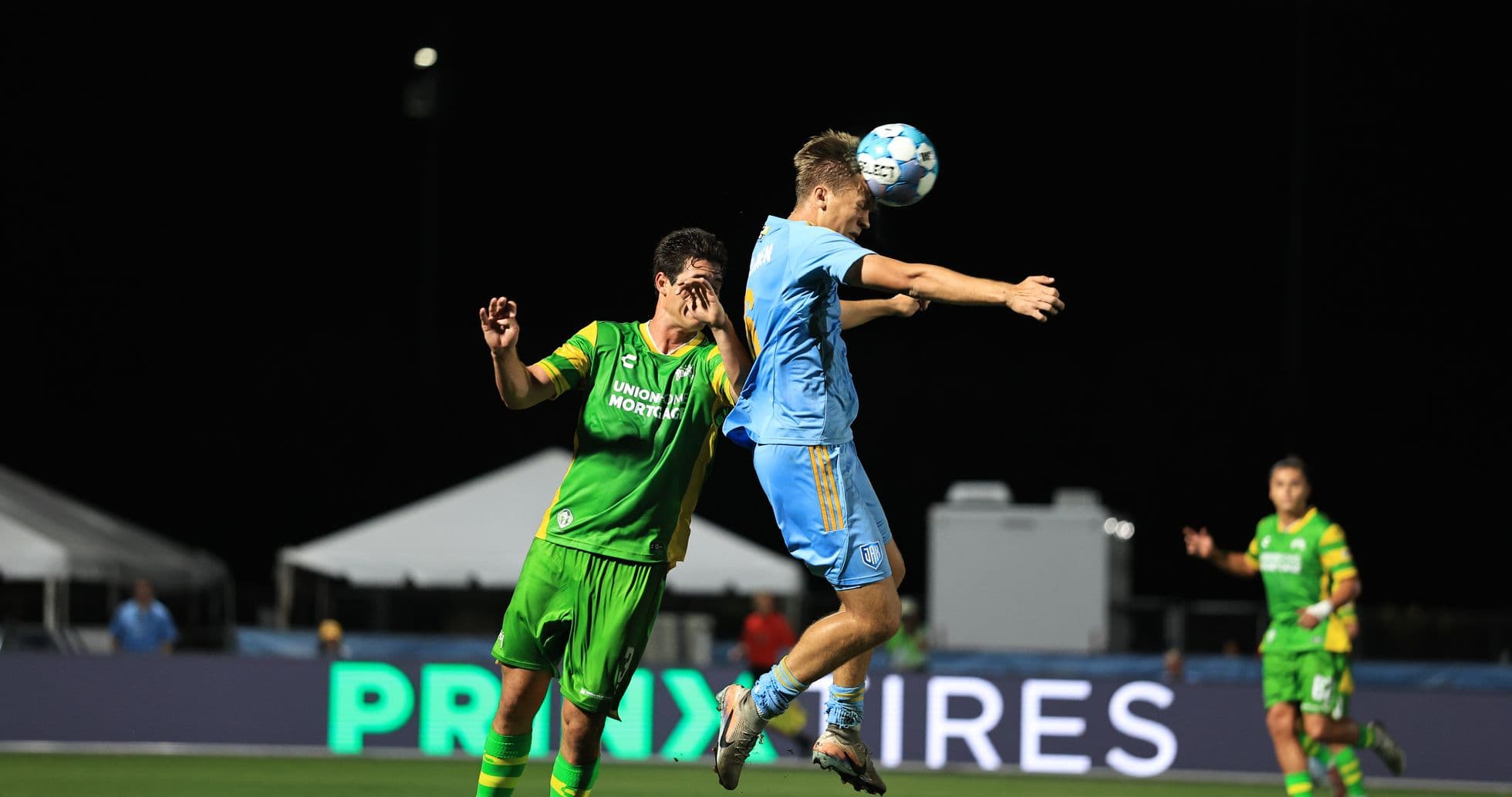 Players competing for the ball during match
