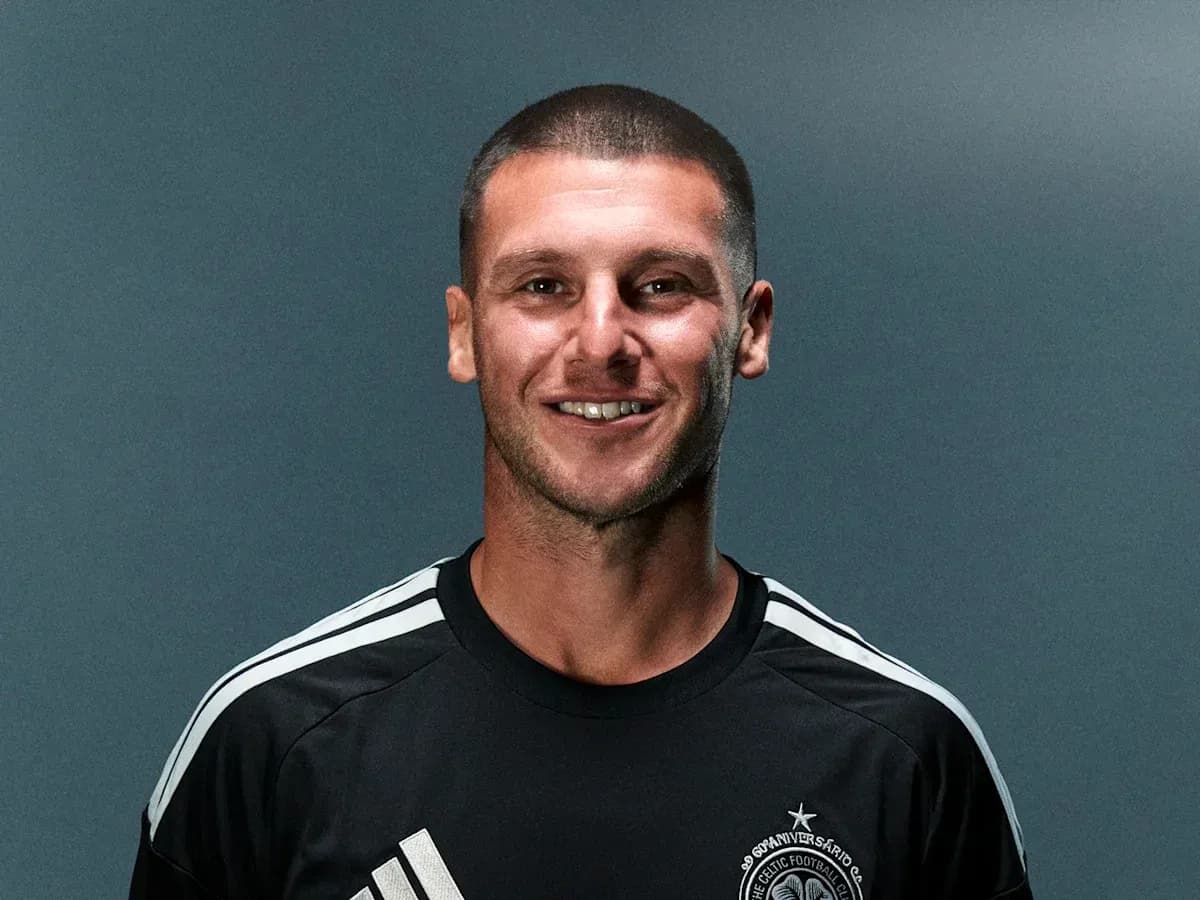 Athlete posing in team jersey with logo