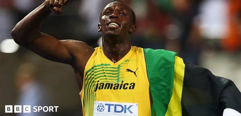 Usain Bolt celebrating victory with Jamaican flag
