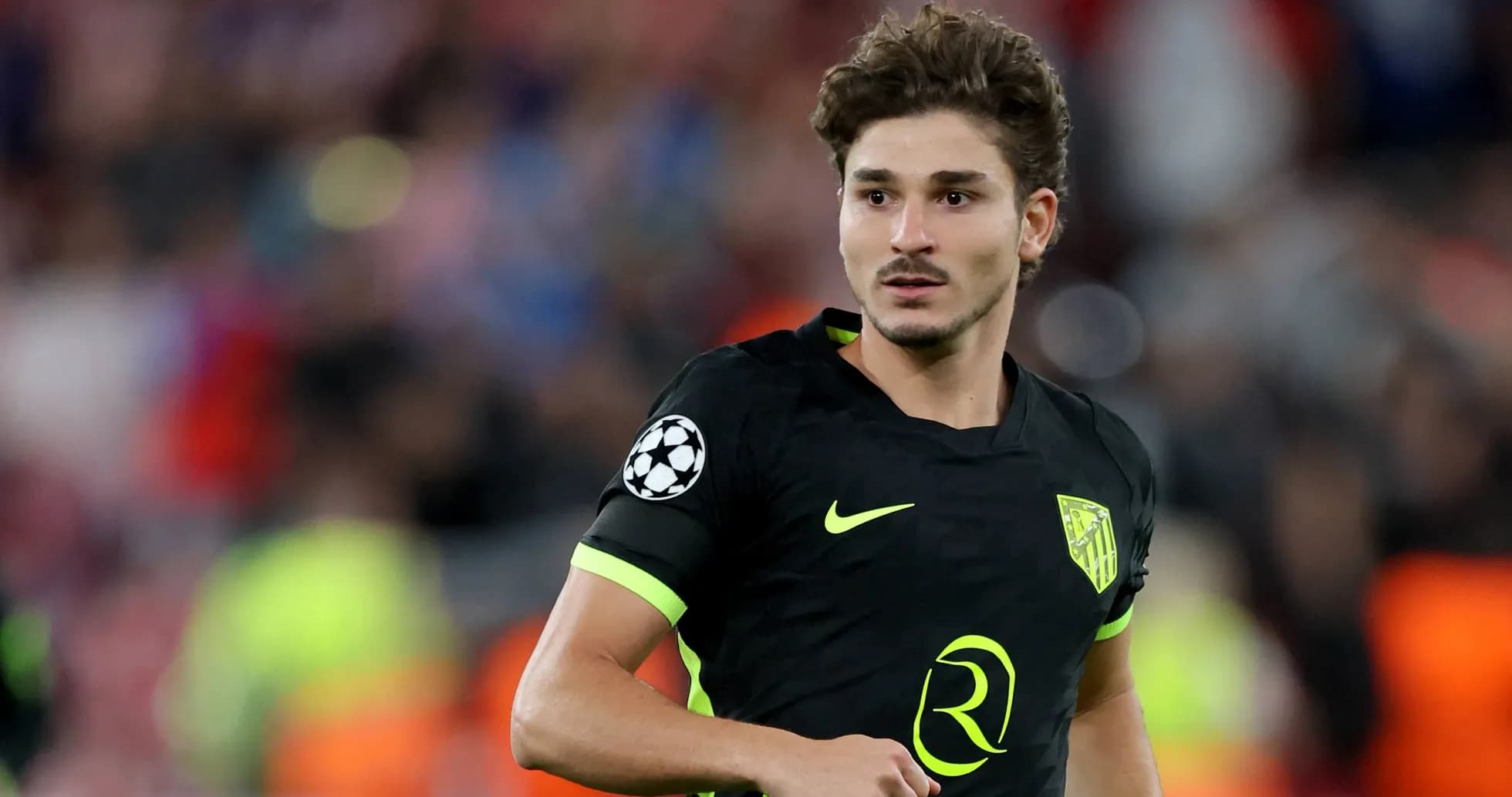 Player in black kit during a Champions League match
