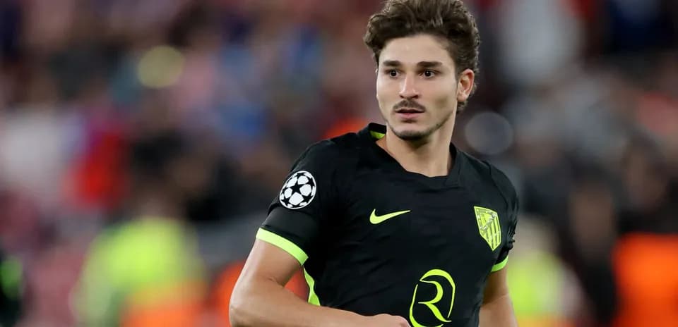 Player in black kit during a Champions League match