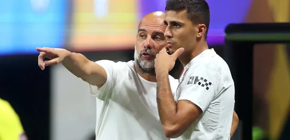 Coach discussing strategy with player on sidelines