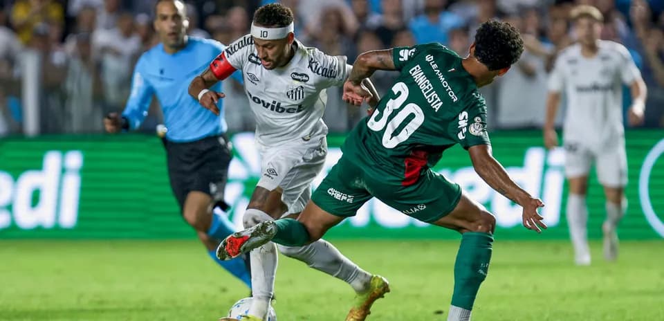 Player in white dribbling past opponent in green
