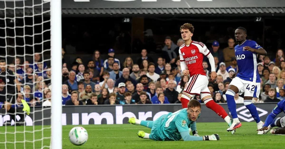 Arsenal player celebrating after scoring against goalkeeper