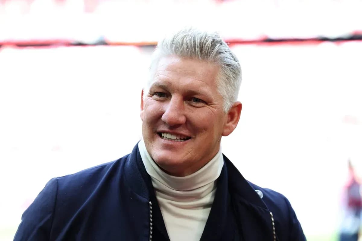 Smiling man in a jacket at stadium entrance