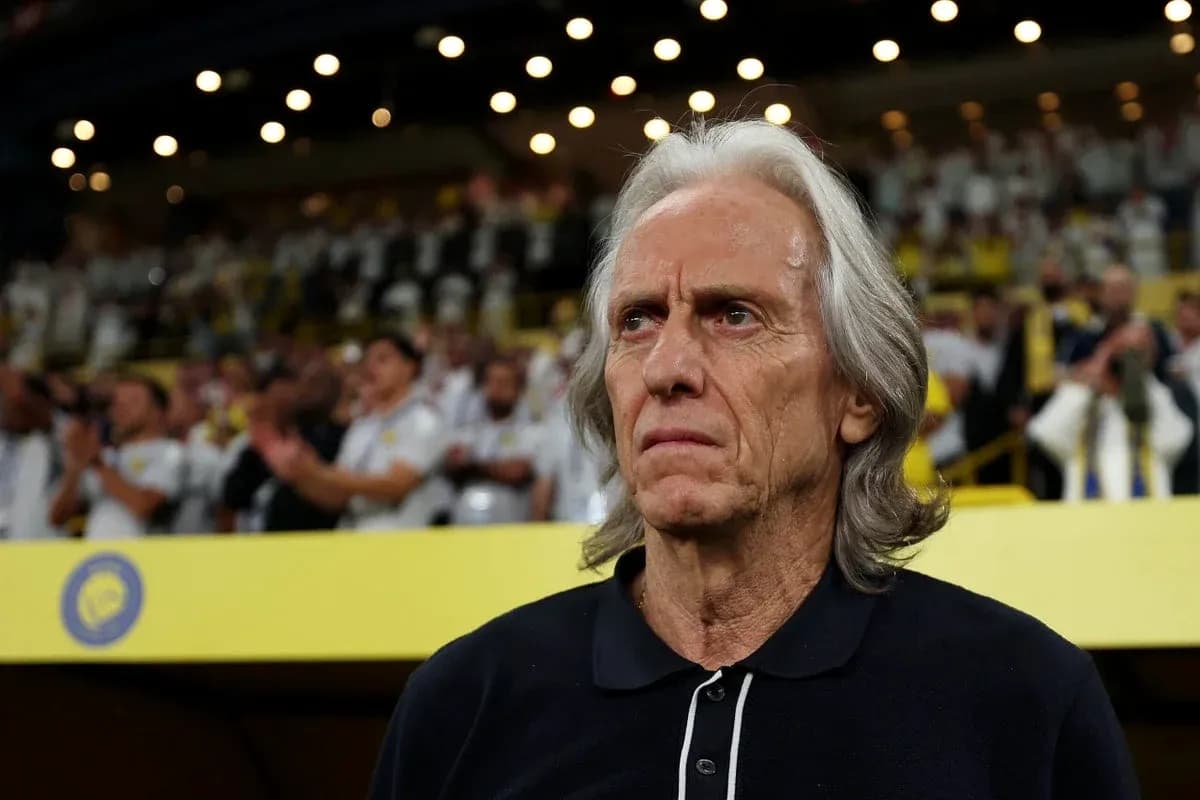 Coach observing match with fans in background