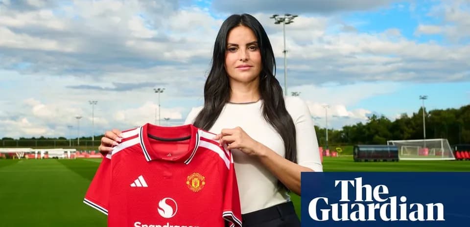 Person holding Manchester United jersey at training ground