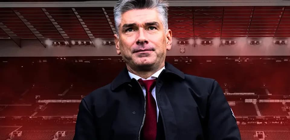 Coach standing in front of stadium background