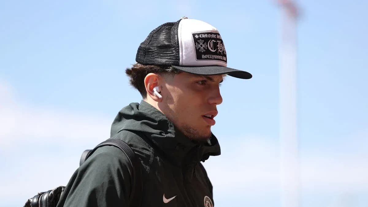 Player wearing cap and earbuds walking outdoors