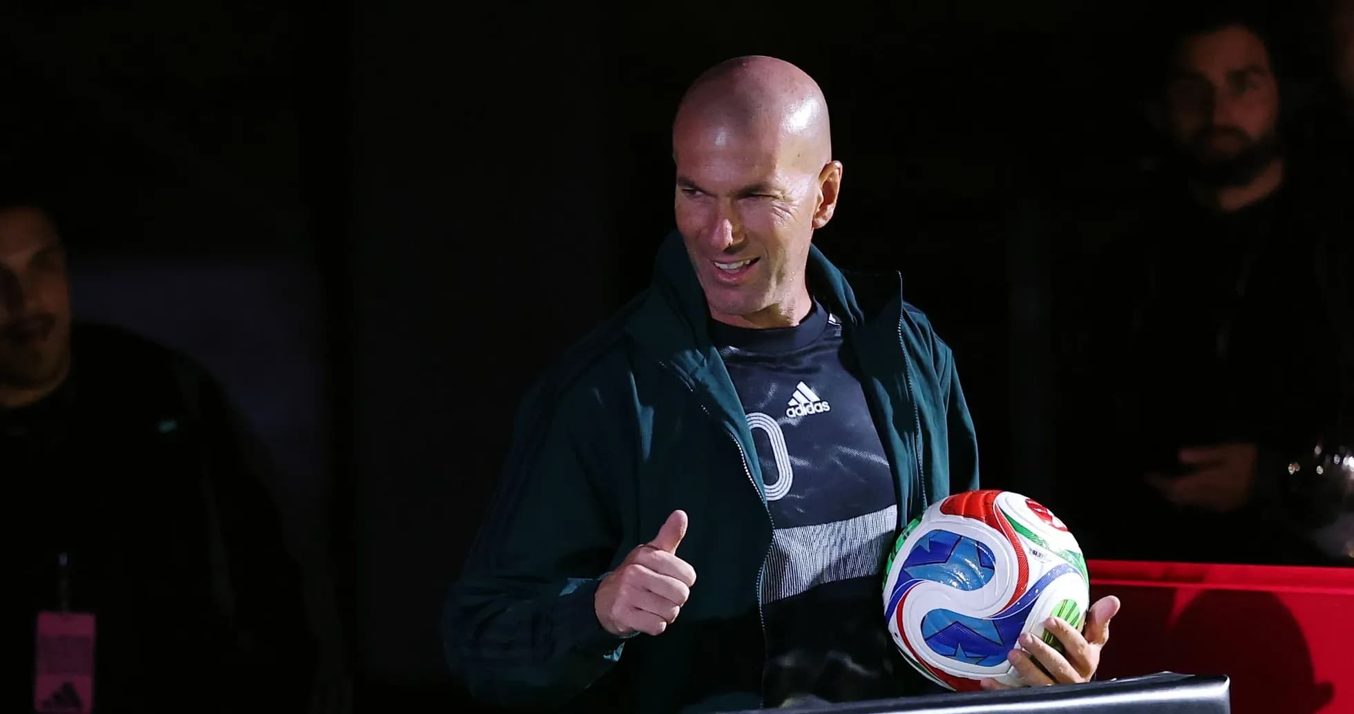 Zinedine Zidane giving a thumbs up with a soccer ball