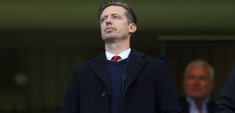 Man in suit observing from the stands