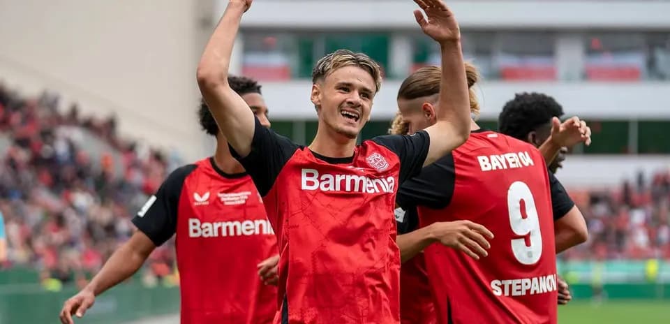 Bayer Leverkusen players celebrating a goal on field