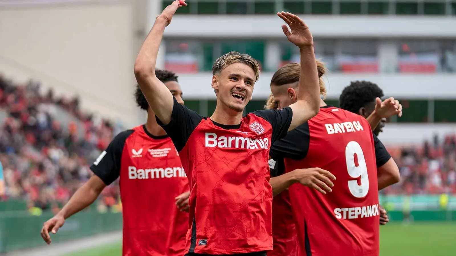 Bayer Leverkusen players celebrating a goal on field