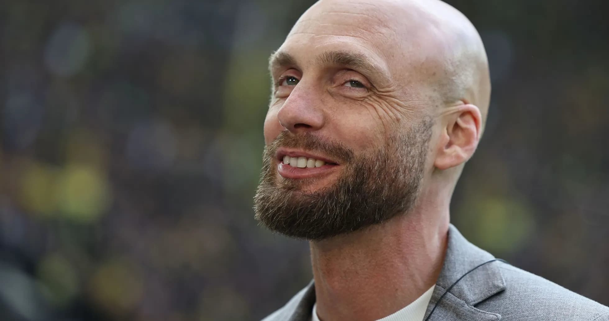 Bald man with a beard smiling at event
