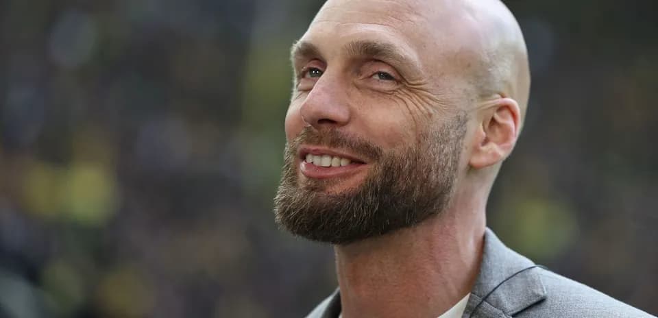 Bald man with a beard smiling at event