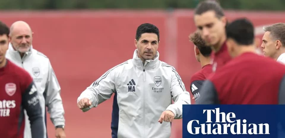 Manager instructing players during Arsenal training session