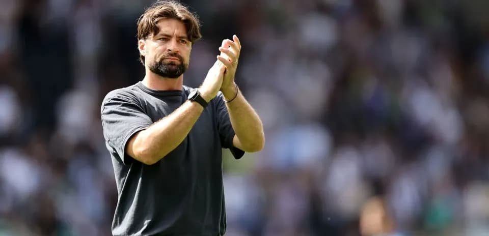 Coach applauding fans during a match