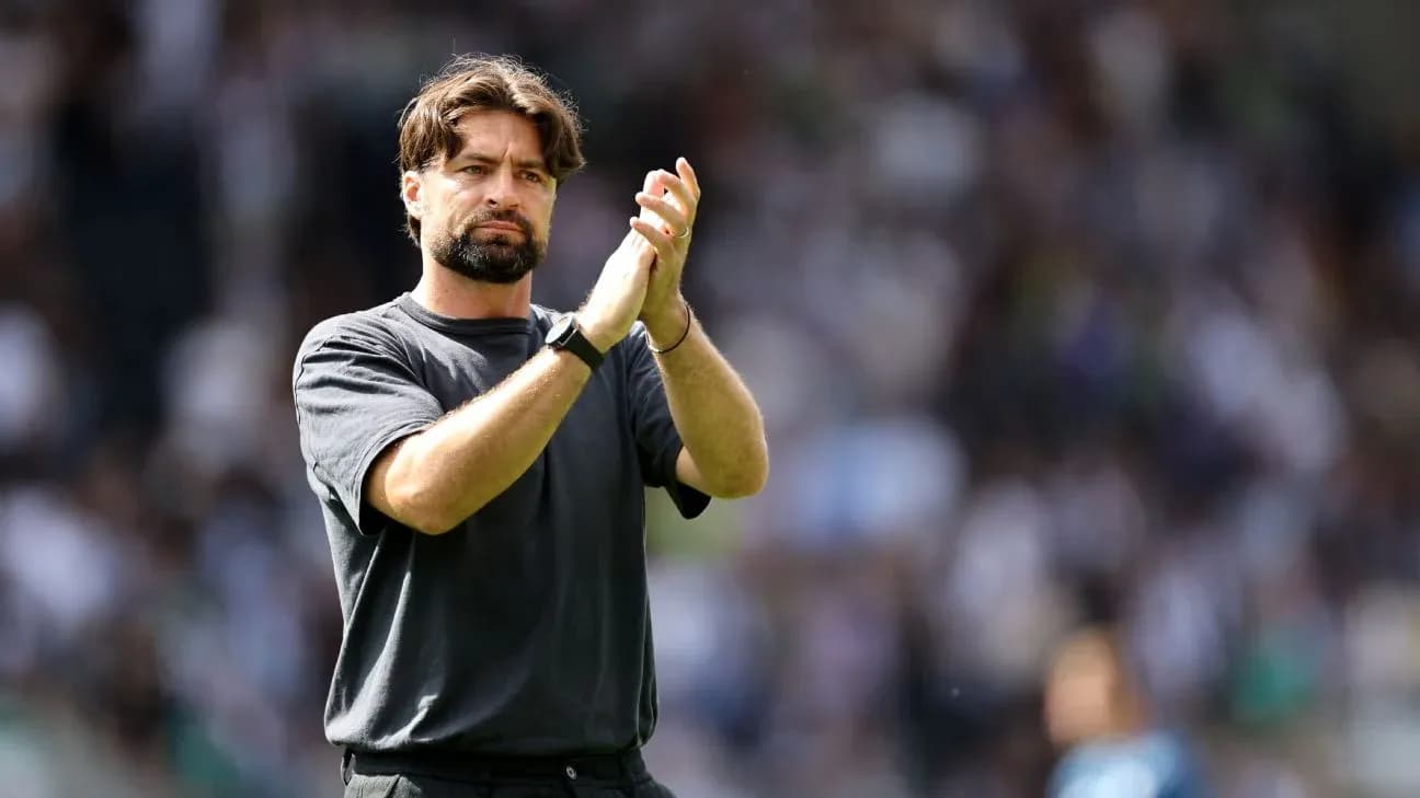 Coach applauding fans during a match
