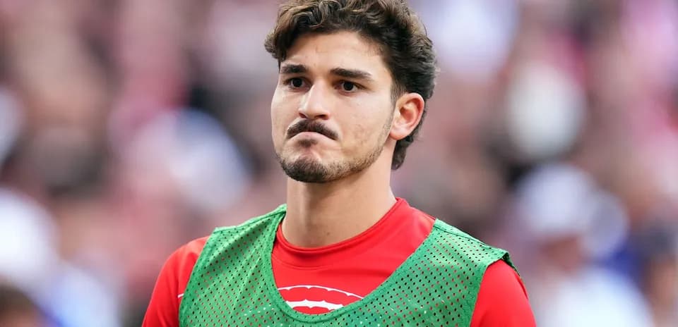 Player in training bib on the sidelines