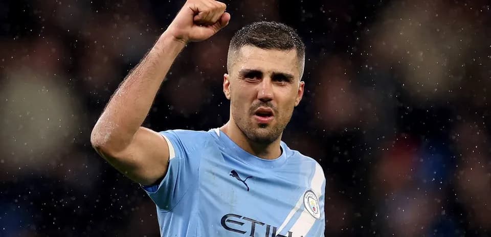 Player celebrating with raised fist in Manchester City jersey