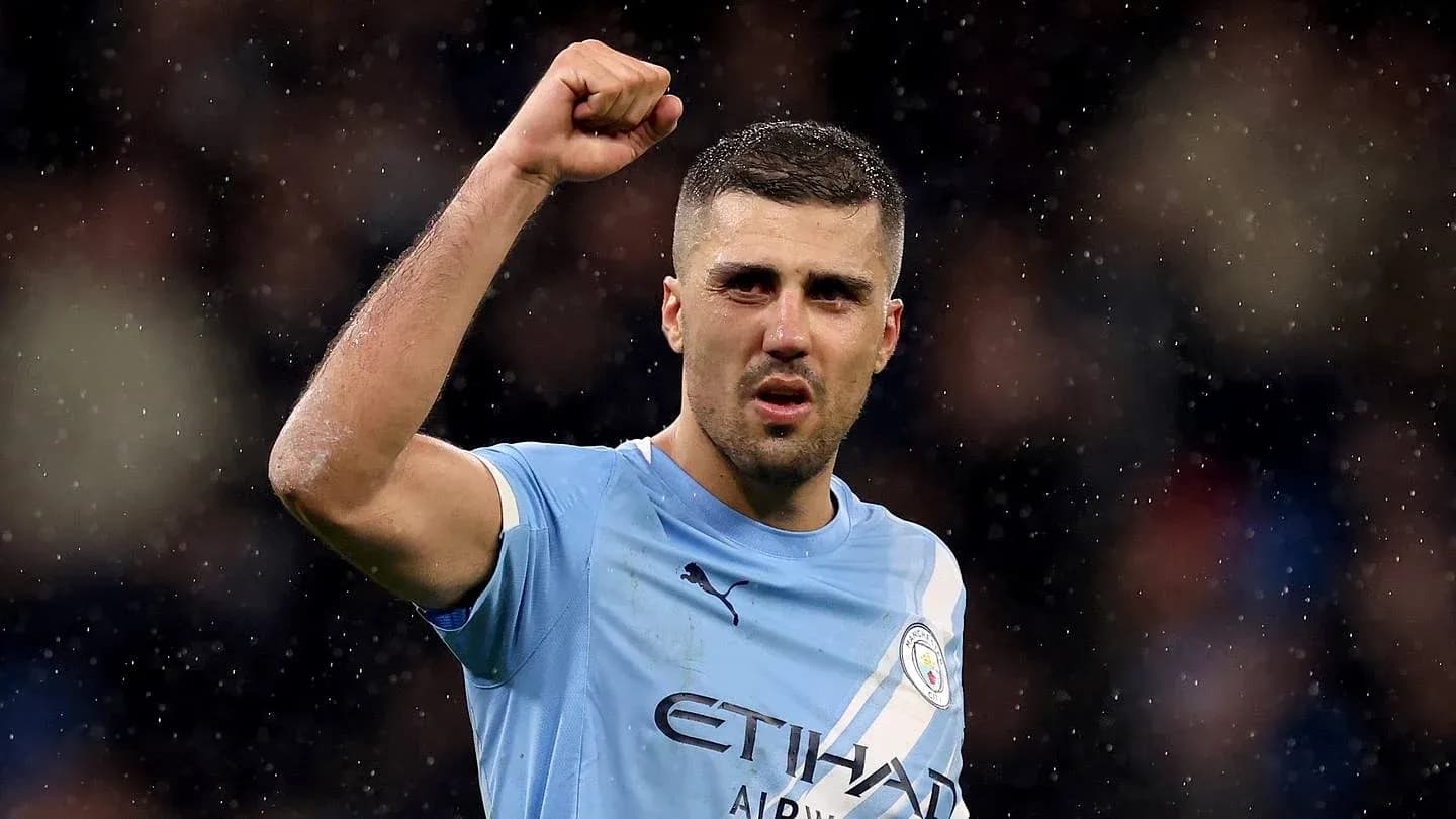 Player celebrating with raised fist in Manchester City jersey