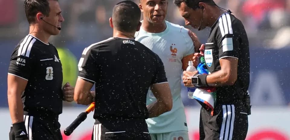 Kylian Mbappé speaking with match officials